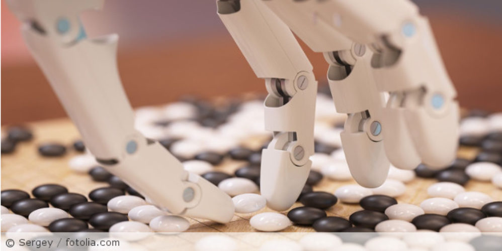 Eine Roboterhand die versucht kleine Steine aufzuheben.