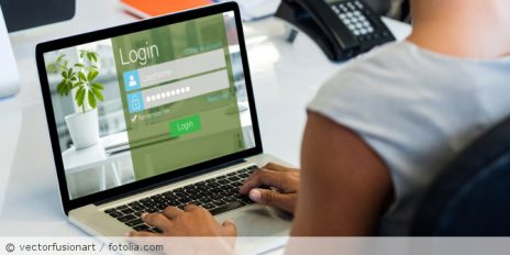 Eine Frau die auf ihrem Laptop ein Passwort eingibt.