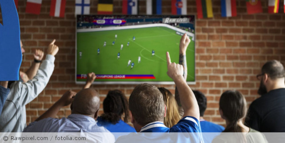 Menschen schauen gemeinsam Fußball.