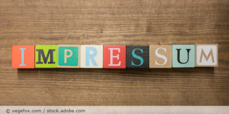 Würfel mit der Aufschrift "IMPRESSUM".
