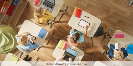 Schüler arbeiten im Klassenzimmer mit Laptops und Tablets.