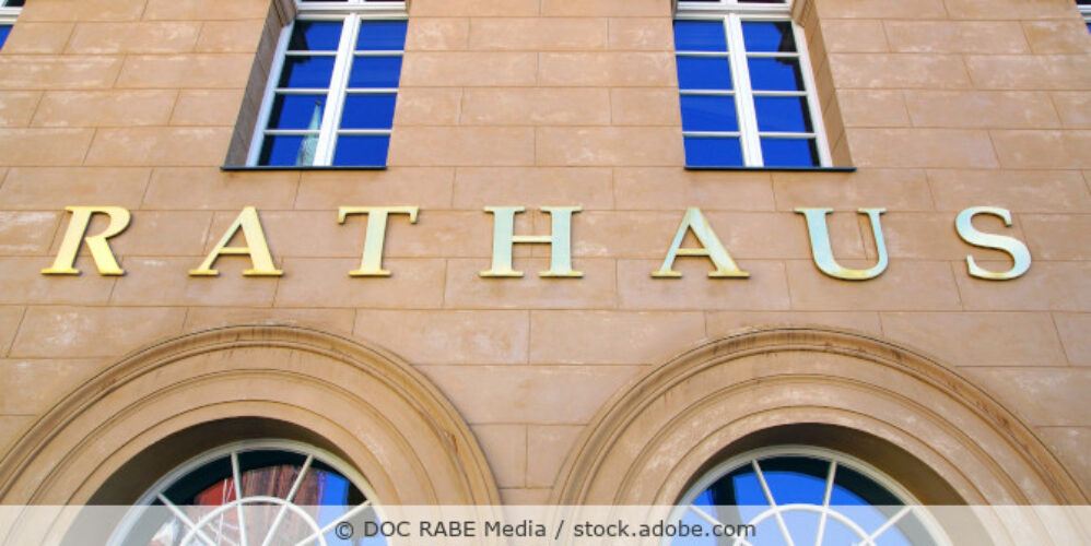 Außenansicht eines alten Rathauses mit dem Wort Rathaus in goldenen Buchstaben über dem Eingang.