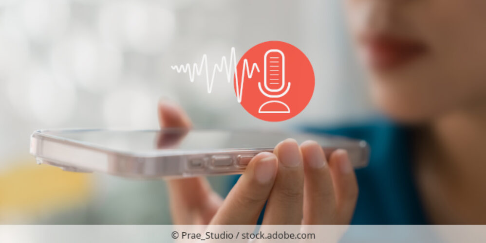 Woman recording a voice memo on a smartphone.