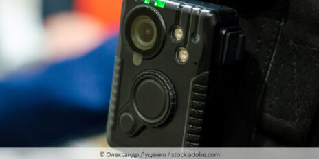 Bodycam, die an Hemdtasche einer Person befestigt ist.